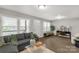 Comfortable living room features neutral tones, hardwood floors, and large windows offering great lighting at 6057 Highway 97 Hwy, Hickory Grove, SC 29717