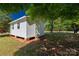 Outbuilding featuring new paint, an out-swing entry door and a comfortable backyard setting at 6057 Highway 97 Hwy, Hickory Grove, SC 29717