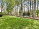 Spacious backyard featuring lush green grass and a trampoline for outdoor enjoyment at 6114 Abergele Ln, Matthews, NC 28104