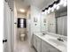 Bright bathroom features a double sink vanity with white cabinets and a tiled floor at 6114 Abergele Ln, Matthews, NC 28104