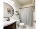 Bathroom showcases a single sink vanity, toilet, and shower with neutral colors throughout at 6114 Abergele Ln, Matthews, NC 28104