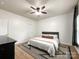 Bedroom featuring a neutral color palette, ceiling fan, and minimalist decor at 6114 Abergele Ln, Matthews, NC 28104
