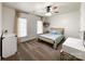 This bedroom offers lots of natural light with a ceiling fan and neutral decor at 6114 Abergele Ln, Matthews, NC 28104