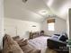 Upstairs bonus room with carpet floors, comfortable sofas, and a window with blinds at 6114 Abergele Ln, Matthews, NC 28104