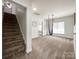 Bonus room near stairs with neutral carpet and hammock at 6114 Abergele Ln, Matthews, NC 28104