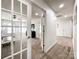 Hallway leading to rooms featuring French doors and neutral carpet at 6114 Abergele Ln, Matthews, NC 28104