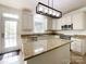 Bright kitchen with granite counters, stainless steel appliances, and an island with extra space for dining at 6114 Abergele Ln, Matthews, NC 28104