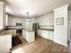 White kitchen with granite countertops, stainless steel appliances, and a center island at 6114 Abergele Ln, Matthews, NC 28104