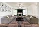 This living room showcases a fireplace, ceiling fan, neutral-toned furnishings, and a hardwood floor at 6114 Abergele Ln, Matthews, NC 28104