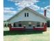 Quaint one-story house with a white exterior, red trim, and a welcoming front porch at 6309 New Town Rd, Waxhaw, NC 28173