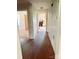Hallway view to the kitchen with painted wood floors of the home at 6309 New Town Rd, Waxhaw, NC 28173