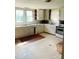 Vintage kitchen featuring neutral cabinets and counters with a white refrigerator and stove at 6309 New Town Rd, Waxhaw, NC 28173