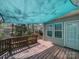 A wooden deck with a blue canopy covering part of it, great for enjoying the outdoors at 7524 Common Oak Dr, Stanley, NC 28164