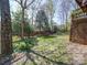 Lush backyard with vibrant greenery and an enclosed privacy fence at 7524 Common Oak Dr, Stanley, NC 28164