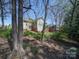 Home with lush greenery, mature trees, and a well-maintained lawn at 7524 Common Oak Dr, Stanley, NC 28164