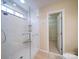 Clean shower featuring a glass door and built in shower caddy at 7524 Common Oak Dr, Stanley, NC 28164