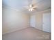 Carpeted bedroom with ceiling fan and neutral colored walls at 7524 Common Oak Dr, Stanley, NC 28164