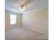 Carpeted bedroom with ceiling fan and neutral colored walls at 7524 Common Oak Dr, Stanley, NC 28164