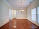 Bright dining room with hardwood floors, elegant chandelier, large windows, and beautiful trim at 7524 Common Oak Dr, Stanley, NC 28164