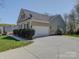 Exterior view of a one-story home with a two-car garage and long driveway at 7524 Common Oak Dr, Stanley, NC 28164