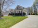 Charming one-story home with gray siding, red shutters, and well-manicured lawn at 7524 Common Oak Dr, Stanley, NC 28164