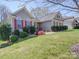 Charming single-story home with red shutters and well-manicured lawn at 7524 Common Oak Dr, Stanley, NC 28164