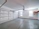 View of the attached two car garage with ample space and shelving at 7524 Common Oak Dr, Stanley, NC 28164