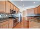 Modern kitchen with stainless steel appliances, granite countertops, tile backsplash, and maple cabinetry at 7524 Common Oak Dr, Stanley, NC 28164