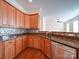 A stylish kitchen featuring stainless steel appliances, granite countertops, and beautiful tile backsplash at 7524 Common Oak Dr, Stanley, NC 28164