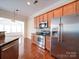 Modern kitchen with stainless steel appliances, granite countertops, and maple cabinetry at 7524 Common Oak Dr, Stanley, NC 28164