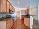 Spacious kitchen features stainless appliances, granite countertops, and hardwood flooring at 7524 Common Oak Dr, Stanley, NC 28164