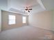Large main bedroom with neutral carpeting, two windows, and ceiling fan at 7524 Common Oak Dr, Stanley, NC 28164