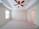 This is a large main bedroom featuring neutral carpeting and a ceiling fan at 7524 Common Oak Dr, Stanley, NC 28164