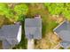 This overhead shot reveals houses with decks nestled in a lush, green, and private backyard at 8619 Delamere Ln, Charlotte, NC 28269