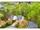 An aerial view captures homes with well-maintained roofs, driveways, and surrounding trees at 8619 Delamere Ln, Charlotte, NC 28269