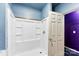 Bathroom with white shower stall, light blue walls, and white door at 8619 Delamere Ln, Charlotte, NC 28269