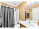 Cozy bathroom featuring a shower with curtain, vanity with a large mirror, and neutral color palette at 8619 Delamere Ln, Charlotte, NC 28269
