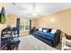 Cozy bedroom with a large window, a daybed and an arcade game machine at 8619 Delamere Ln, Charlotte, NC 28269