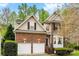 Charming two-story home featuring a brick facade and a two-car garage and manicured landscaping at 8619 Delamere Ln, Charlotte, NC 28269