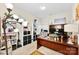 Well-lit home office with built-in shelving, a large desk, and comfortable seating for remote work at 8619 Delamere Ln, Charlotte, NC 28269