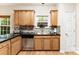 Kitchen with granite countertops, stainless steel dishwasher, hardwood floors and modern backsplash at 8619 Delamere Ln, Charlotte, NC 28269