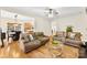 Open-concept living room with hardwood floors and view into the dining area at 8619 Delamere Ln, Charlotte, NC 28269