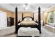 Elegant main bedroom featuring a four-poster bed, plush seating, and ample natural light at 8619 Delamere Ln, Charlotte, NC 28269