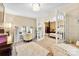 Charming sitting room with French doors to the bedroom, featuring a vanity table and neutral color scheme at 8619 Delamere Ln, Charlotte, NC 28269