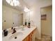 Bathroom featuring a wood vanity and a large mirror at 920 Ashworth Dr, Gastonia, NC 28054