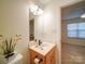 Bathroom featuring vanity with framed mirror and decor with a view to another room in the home at 920 Ashworth Dr, Gastonia, NC 28054