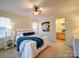 Bright bedroom with a ceiling fan, a decorative headboard, and an ensuite bathroom at 920 Ashworth Dr, Gastonia, NC 28054