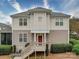 Charming two-story townhome featuring a red door, well-maintained landscaping, and a welcoming entryway at 920 Ashworth Dr, Gastonia, NC 28054