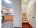 Open kitchen view showing wood cabinets, stainless appliances, and view of stairway at 920 Ashworth Dr, Gastonia, NC 28054