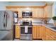 Kitchen featuring stainless steel appliances, wood cabinets, and tile flooring at 920 Ashworth Dr, Gastonia, NC 28054